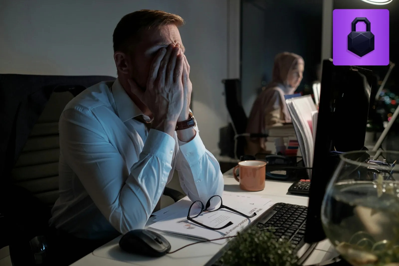 A stressed attorney sitting at a desk after a client data disclosure