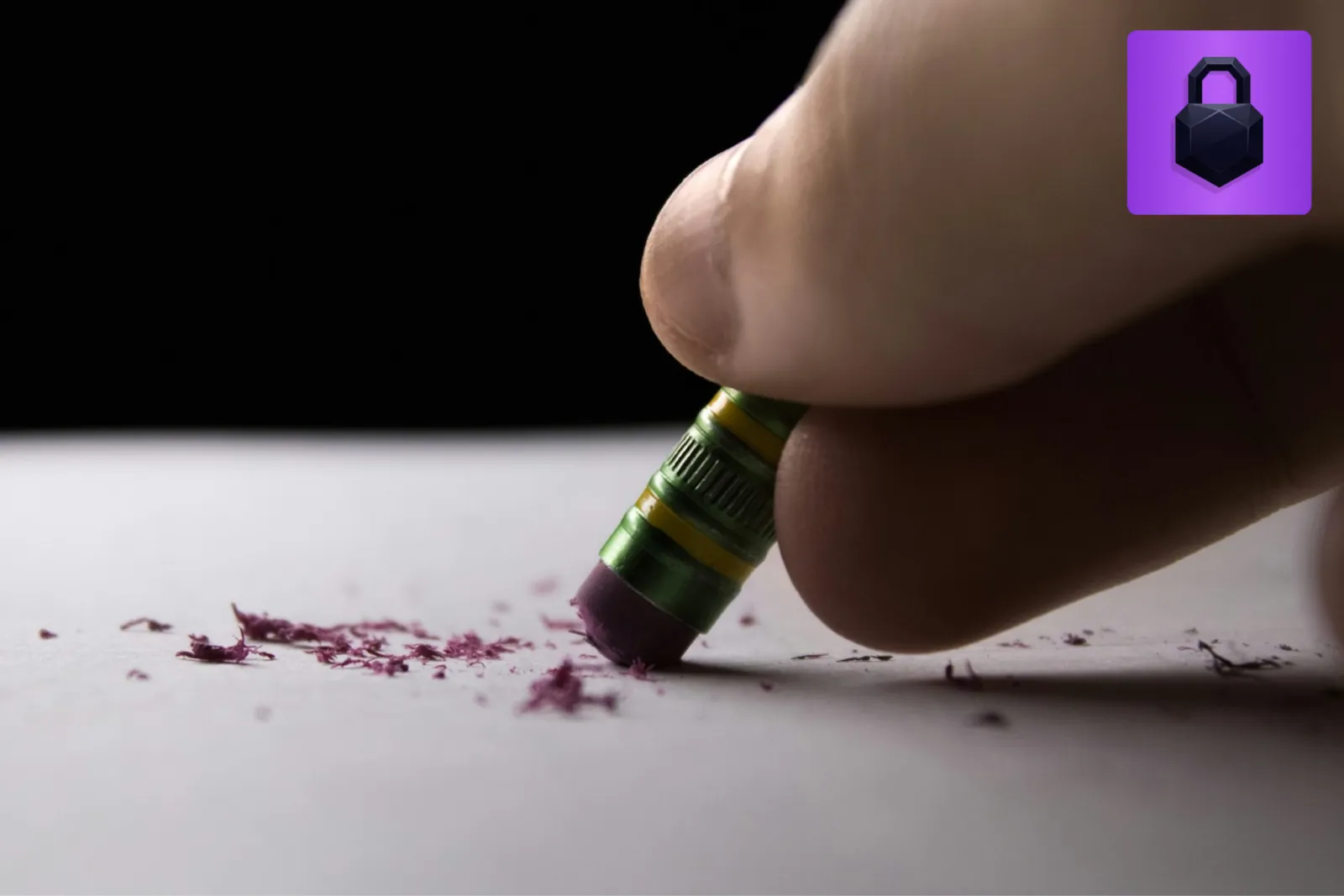 A pencil eraser removing marks from paper, illustrating redaction