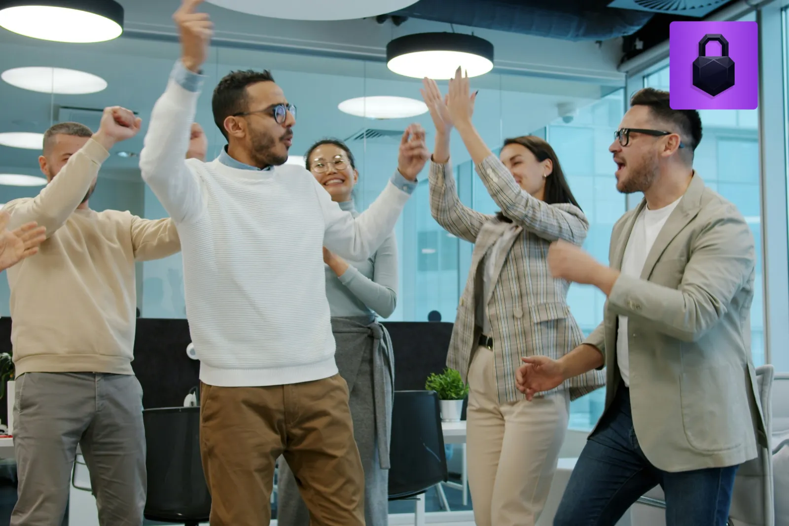 A law firm team celebrating with a high five in a bright modern office