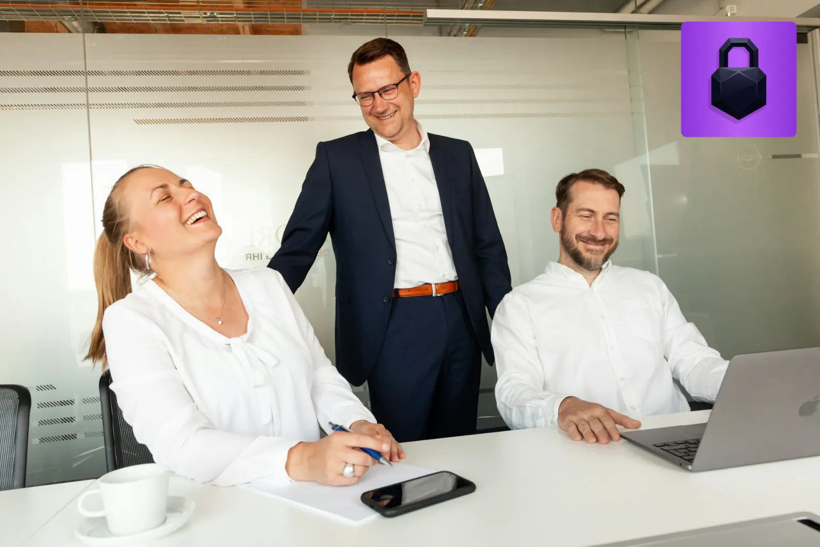 Paralegals and attorneys laughing together in a bright law office